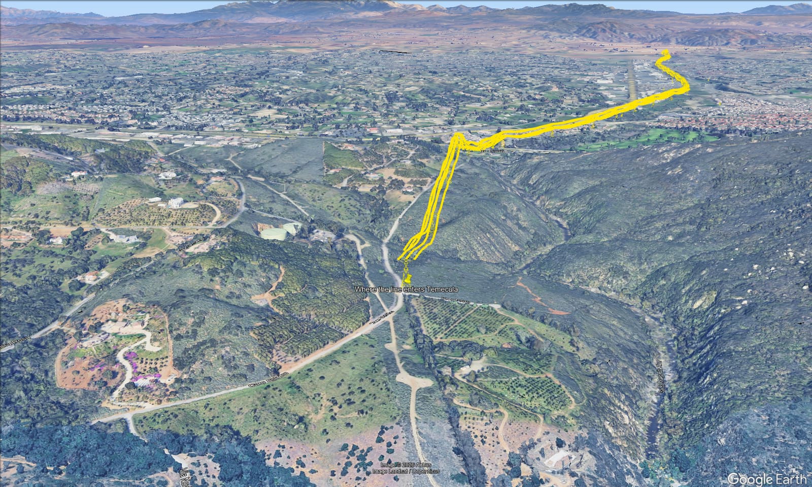 Aerial view west of Temecula where the proposed corridor enters the city, with illustrative lattice towers highlighted in yellow.